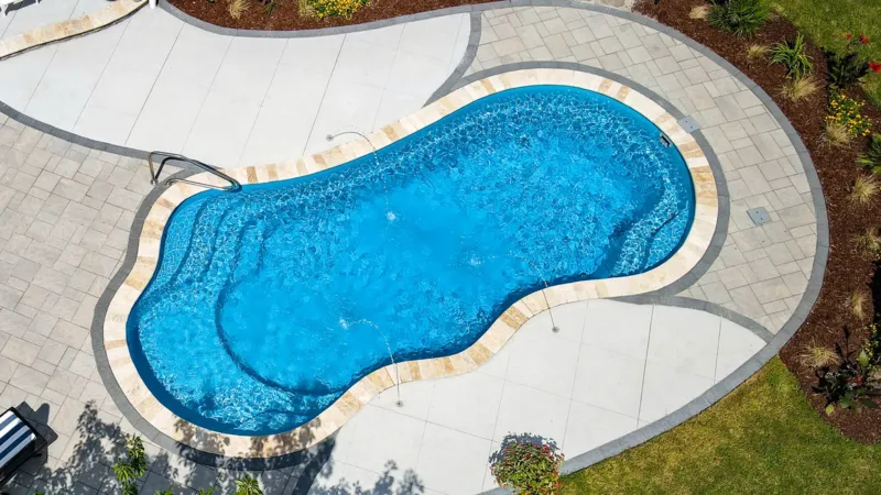 DJI_0878-800x450 Image of a freeform fiberglass pool with decorative paver patio and built-in water features